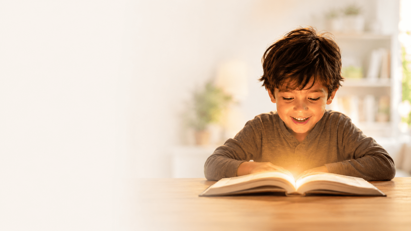 A child delighting over a glowing open book — learning made magical through Graphonic Mnemonics